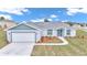 Beautiful home with a two-car garage and well manicured landscaping at 2809 Ne 43Rd Rd, Ocala, FL 34470