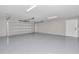 Spacious garage with epoxy flooring and an attached door to the house at 2809 Ne 43Rd Rd, Ocala, FL 34470