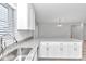 Kitchen features white cabinets, granite countertops and a large island at 2809 Ne 43Rd Rd, Ocala, FL 34470