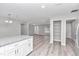 Open concept kitchen and living area with white cabinets and granite countertops at 2809 Ne 43Rd Rd, Ocala, FL 34470