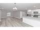 Open living room and kitchen area with light grey walls and wood-look flooring at 2809 Ne 43Rd Rd, Ocala, FL 34470