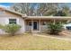 Front porch view of charming house with blue door and white railings at 3742 Ne 4Th St, Ocala, FL 34470