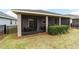 Covered patio and fenced backyard with lush landscaping at 3977 Nw 46Th Ter, Ocala, FL 34482