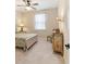 Bedroom with floral bedding and a painted dresser at 3977 Nw 46Th Ter, Ocala, FL 34482