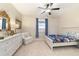 Primary bedroom with large bed, ceiling fan and sitting chair at 3977 Nw 46Th Ter, Ocala, FL 34482