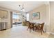 Bright breakfast nook with glass table and wicker chairs near sliding door at 3977 Nw 46Th Ter, Ocala, FL 34482