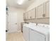 Laundry room with washer, dryer, and cabinets at 3977 Nw 46Th Ter, Ocala, FL 34482