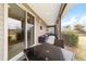 Screened porch with seating area and view of backyard at 3977 Nw 46Th Ter, Ocala, FL 34482