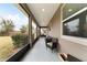 Relaxing screened porch with seating area, overlooking backyard at 3977 Nw 46Th Ter, Ocala, FL 34482