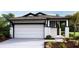 White house with dark trim, two-car garage, and landscaping at 4072 Nw 44Th Cir, Ocala, FL 34482