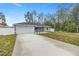 Newly built home with gray exterior, two-car garage, and fenced backyard at 4367 Se 140Th St, Summerfield, FL 34491