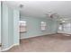 Spacious bedroom with neutral walls, carpet, ceiling fan, and multiple windows at 5370 Sw 85Th Ln, Ocala, FL 34476