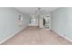 Bright living room featuring carpet, a ceiling fan, and ample natural light at 5370 Sw 85Th Ln, Ocala, FL 34476