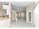Living room with tile floor, view of kitchen and access to patio at 5370 Sw 85Th Ln, Ocala, FL 34476