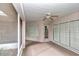 Covered porch with screened enclosure, ceiling fan and door access at 5370 Sw 85Th Ln, Ocala, FL 34476