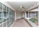 Relaxing screened porch with ceiling fan and sliding glass doors at 5370 Sw 85Th Ln, Ocala, FL 34476