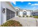 White house with gray garage door, landscaping, and a paved driveway at 5917 Nw 26Th Ln, Ocala, FL 34482