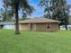 House exterior and expansive grassy backyard at 7090 Se 124Th Ln, Belleview, FL 34420