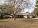 Landscaped yard with mature trees surrounding a ranch-style home at 7326 Sw 101St Street Rd, Ocala, FL 34476