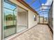 Enclosed patio with sliding glass doors and paver floor at 7732 Sw 94Th Cir, Ocala, FL 34481