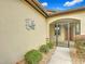 Front entry with a decorative sun and gated porch at 7732 Sw 94Th Cir, Ocala, FL 34481