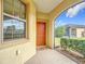 Front entry with orange door and welcome mat at 7732 Sw 94Th Cir, Ocala, FL 34481