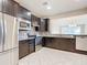 Modern kitchen with dark cabinetry and stainless steel appliances at 7732 Sw 94Th Cir, Ocala, FL 34481