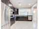 Modern kitchen with dark cabinetry and stainless steel appliances at 7732 Sw 94Th Cir, Ocala, FL 34481
