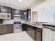 Modern kitchen with dark cabinetry and stainless steel appliances at 7732 Sw 94Th Cir, Ocala, FL 34481