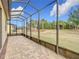 Spacious screened patio with paver floor and backyard view at 7732 Sw 94Th Cir, Ocala, FL 34481
