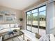 Bright sunroom with glass sliders opening to a backyard view at 7732 Sw 94Th Cir, Ocala, FL 34481