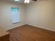 Spacious bedroom with wood-look floors and a window at 9117 Sw 93Rd Cir, Ocala, FL 34481