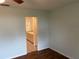 Bedroom with wood-look floors and ensuite bathroom access at 9117 Sw 93Rd Cir, Ocala, FL 34481