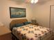 Cozy bedroom featuring a floral quilt and wood flooring at 9117 Sw 93Rd Cir, Ocala, FL 34481