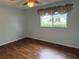 Bright bedroom with wood-look floors and window with backyard view at 9117 Sw 93Rd Cir, Ocala, FL 34481