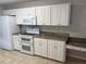 Modern kitchen with granite countertops and white cabinets at 9117 Sw 93Rd Cir, Ocala, FL 34481
