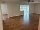 Spacious living room featuring wood-look floors and access to sunroom at 9117 Sw 93Rd Cir, Ocala, FL 34481