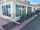 Bright sunroom addition with large windows and landscaping at 9117 Sw 93Rd Cir, Ocala, FL 34481