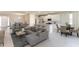 Open-concept living area with gray sectional sofa and adjacent dining area at 9287 Sw 60Th Court Rd, Ocala, FL 34476