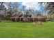 Large grassy backyard with a view of the home's back elevation at 10249 Nw 21St St, Ocala, FL 34482