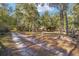 Long driveway leading to a house on a wooded lot at 10249 Nw 21St St, Ocala, FL 34482