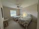 Twin bedroom with two beds, ceiling fan, and window at 11147 Sw 68Th Ct, Ocala, FL 34476