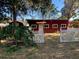 Front view of charming red house with white picket fence at 1175 Cr 463B, Lake Panasoffkee, FL 33538