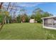 Large backyard with shed, screen enclosure, and garden area at 11852 Se 71St Ct, Belleview, FL 34420