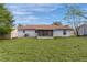 House exterior showcasing a large backyard and screened porch at 11852 Se 71St Ct, Belleview, FL 34420