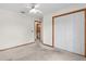 Spacious bedroom with carpet flooring, ceiling fan, and double door closet at 11852 Se 71St Ct, Belleview, FL 34420