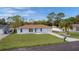 Single-story light blue house with brown roof and spacious yard at 11852 Se 71St Ct, Belleview, FL 34420