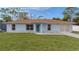 Cute light blue house with a well-maintained lawn at 11852 Se 71St Ct, Belleview, FL 34420