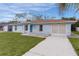 Charming light blue house with driveway and lawn at 11852 Se 71St Ct, Belleview, FL 34420