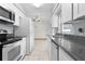 White kitchen cabinets and gray countertops with stainless steel appliances at 11852 Se 71St Ct, Belleview, FL 34420